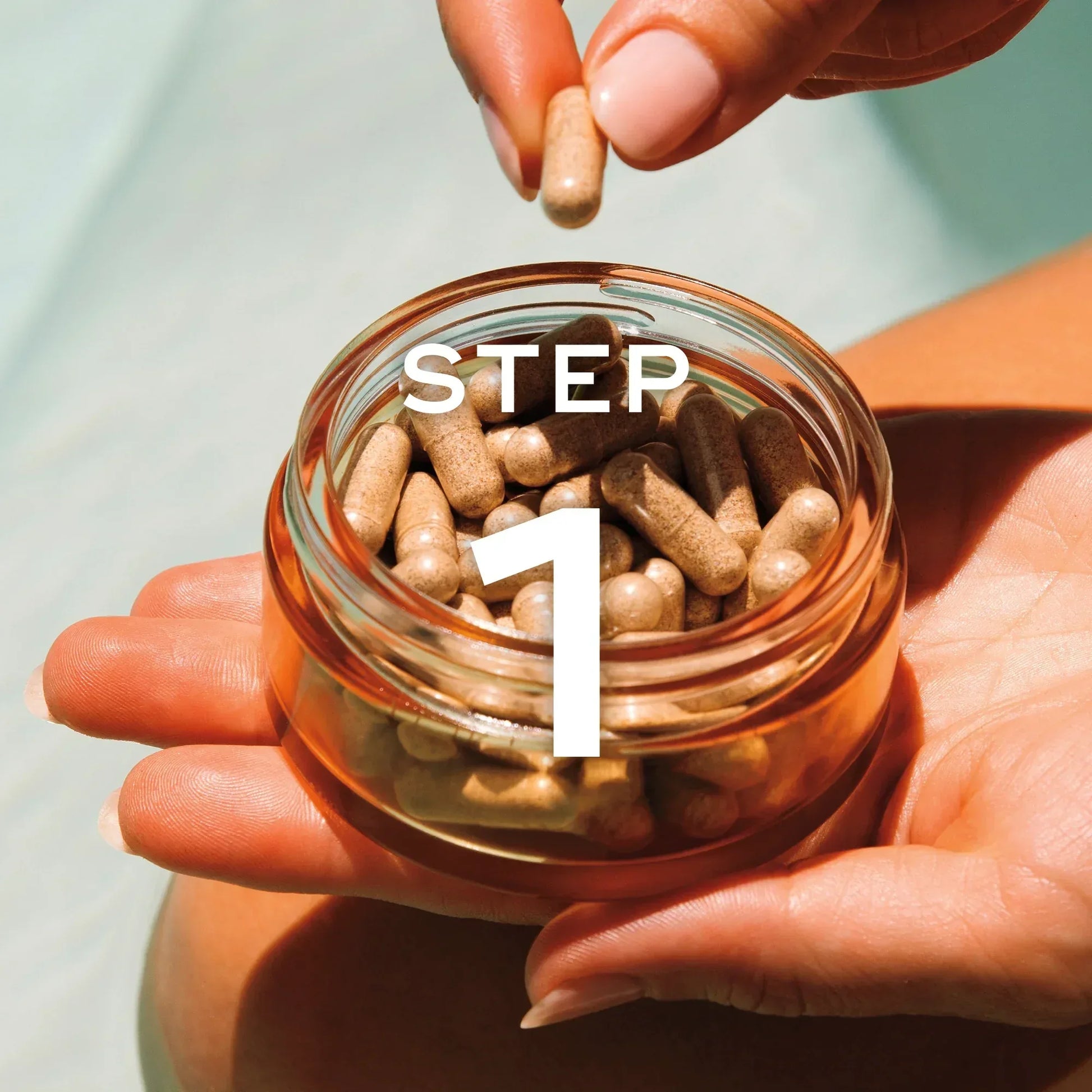 Inside Out Suncare Duo - SUN LOVE SKINCARE Image is of a hand holding the golden Vitamin D + PLE vitamin bottle in one hand, and the other holding one of the supplement capsules with "Step 1" text showing this is step one of the inside-out wellness skincare, sun-care routine.